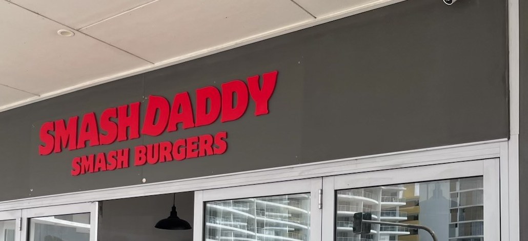 Red dimensional lettering on the grey shopfront fascia